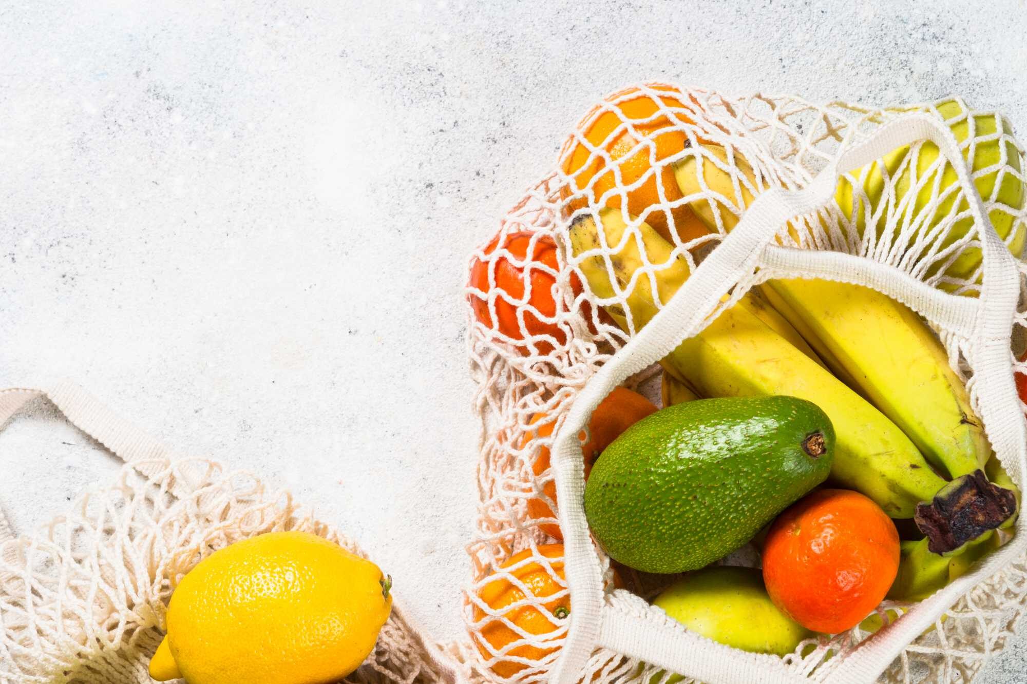 mesh-bag-with-fruits-on-white-background-F4Z58Y8.jpg